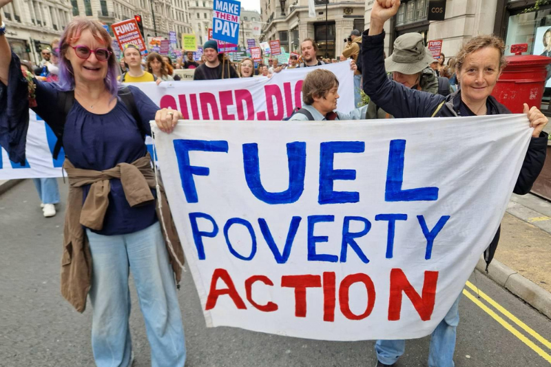 FPA members hold the FPA banner, looking to camera with their fists raised at the Make Them Pay demo in London, September 2025