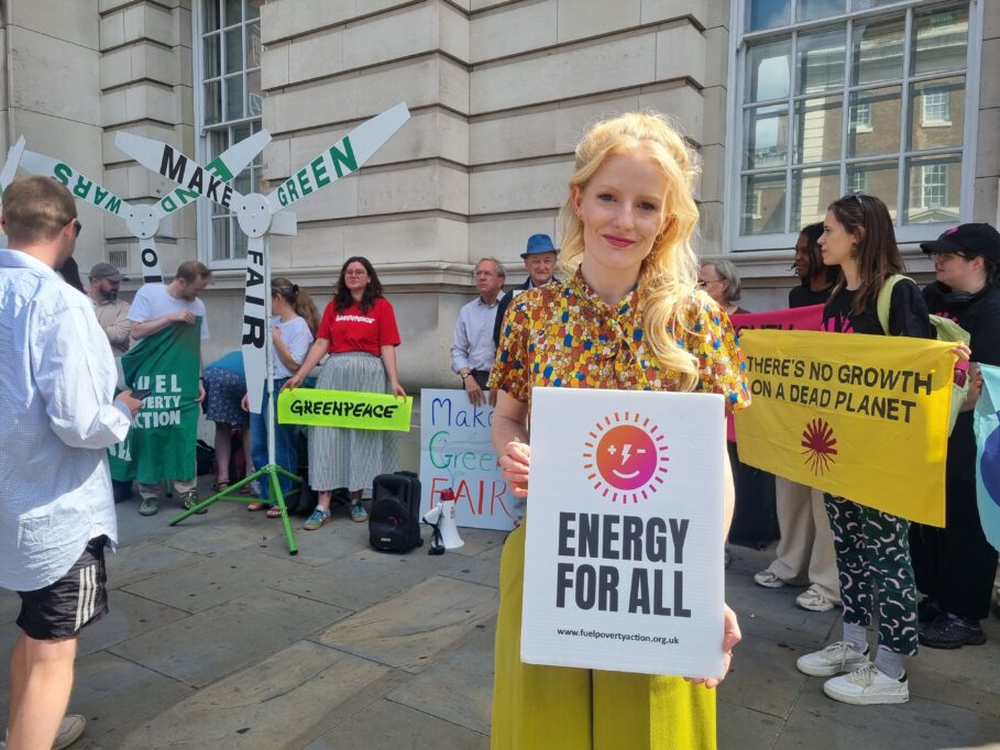 Hannah Spencer MP holds an Energy For All placard outside the Department for Energy at FPA's July 1st Make Green Fair demo